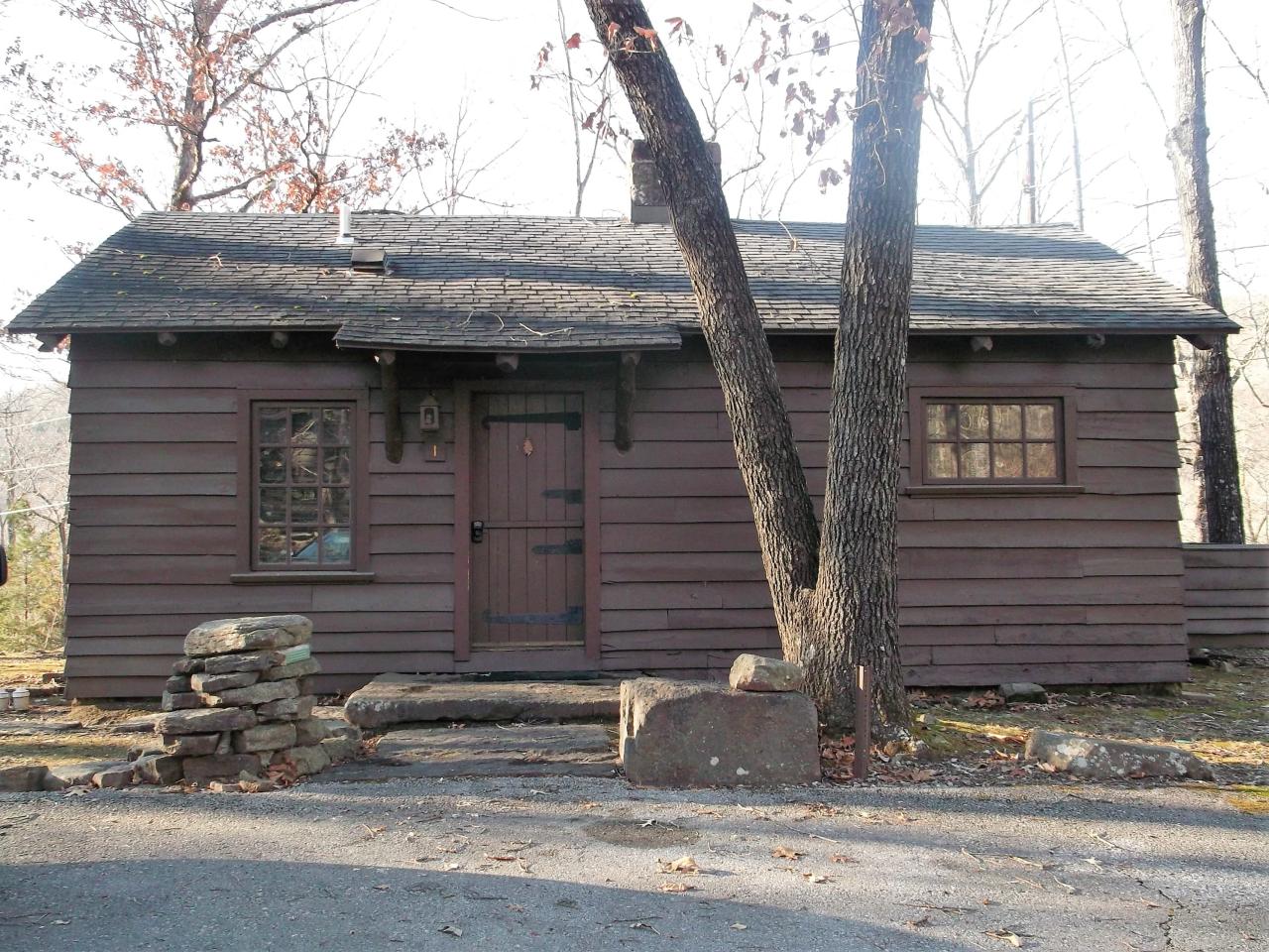 Exterior view of Cabin 1 showing front entrance with tree in front of the cabin